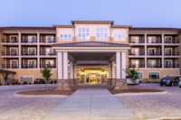 Lakeside Lodge Clemson's porte-cochère and entrance bathed in the pink hues of a Clemson sunset.