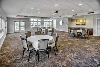 The spacious, light-filled ballroom at Lakeside Lodge Clemson features recessed lighting and contemporary carpeting.