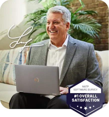 smiling older man sitting at computer