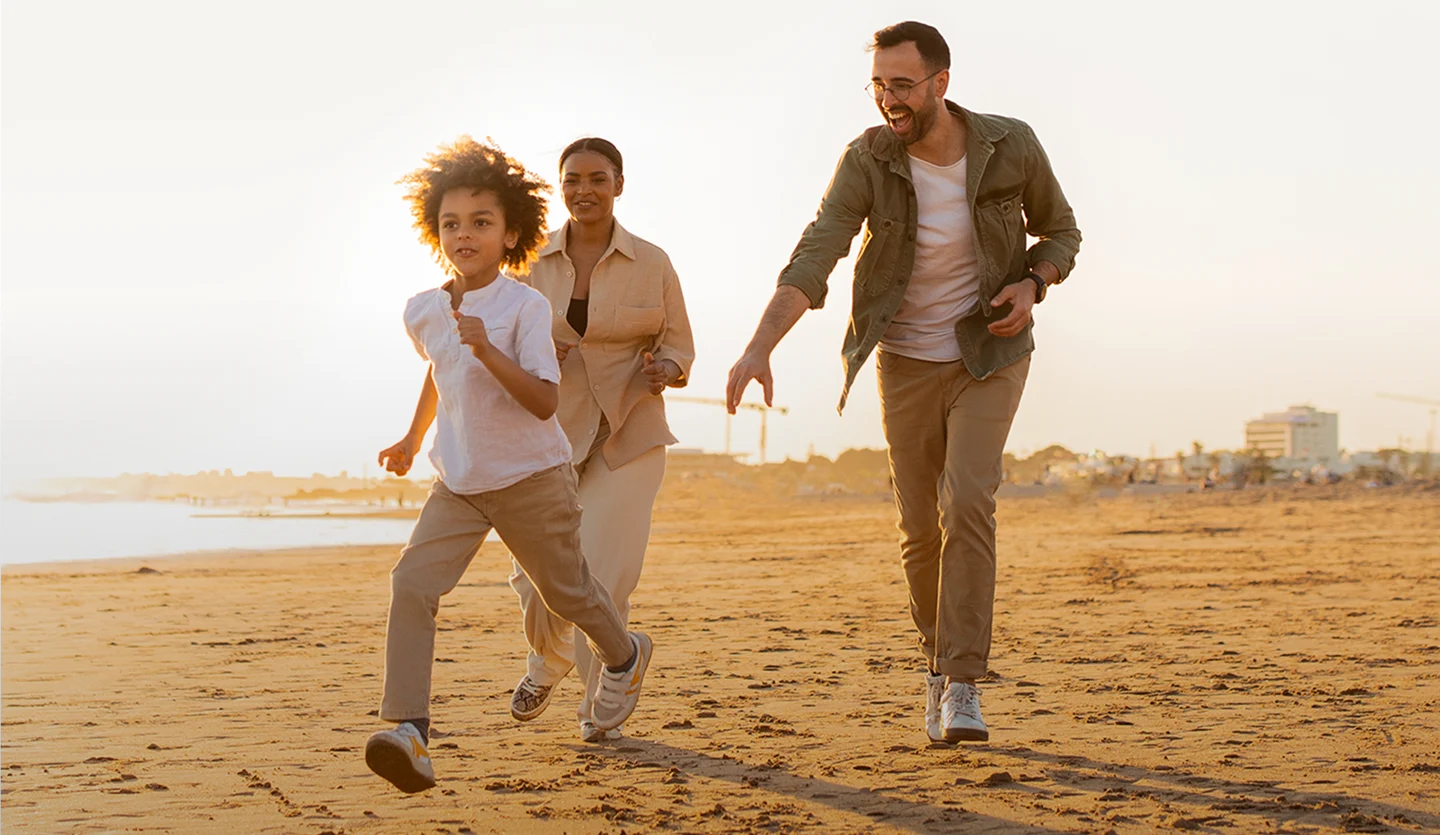 Family running on the beach - Single fullwidth image