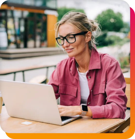 image of a lady at a table on a laptop