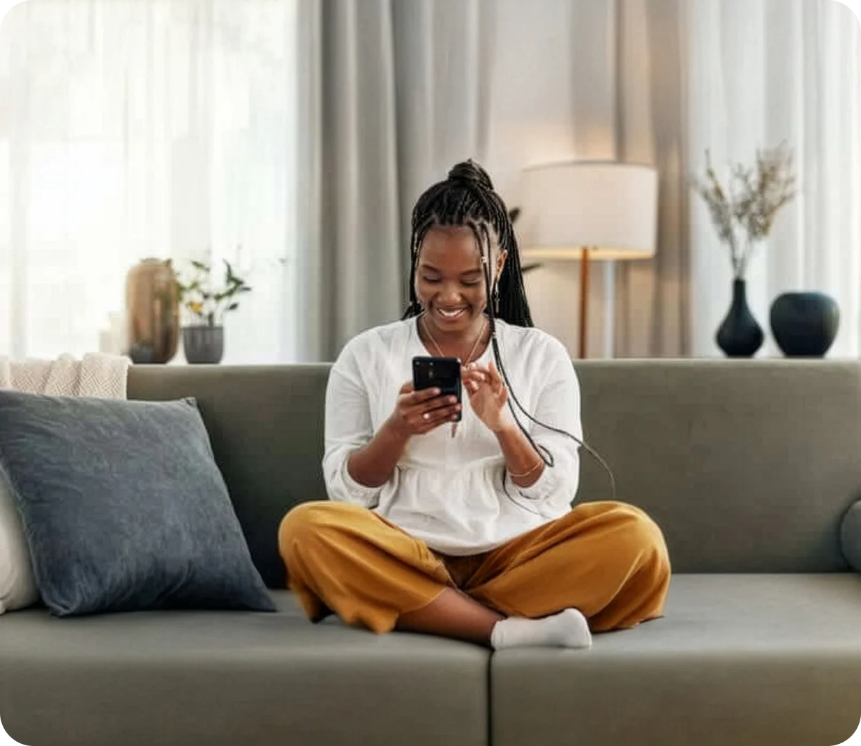 Person on couch looking at phone at tax form 1099 INT