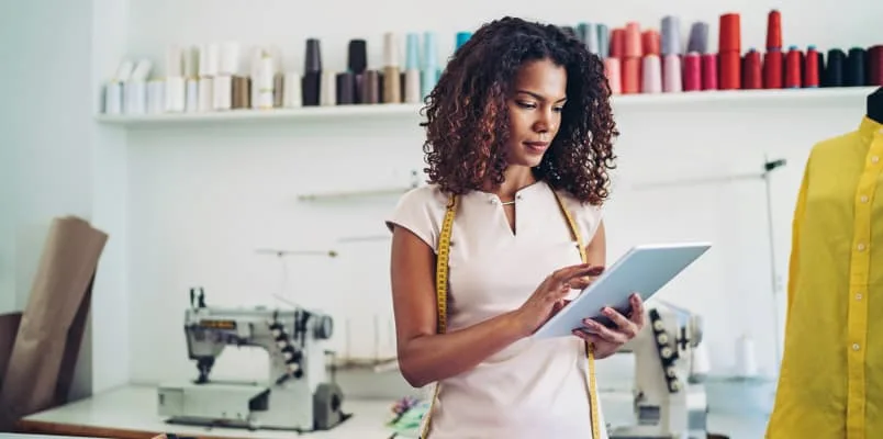 Woman holding iPad in sewing shop