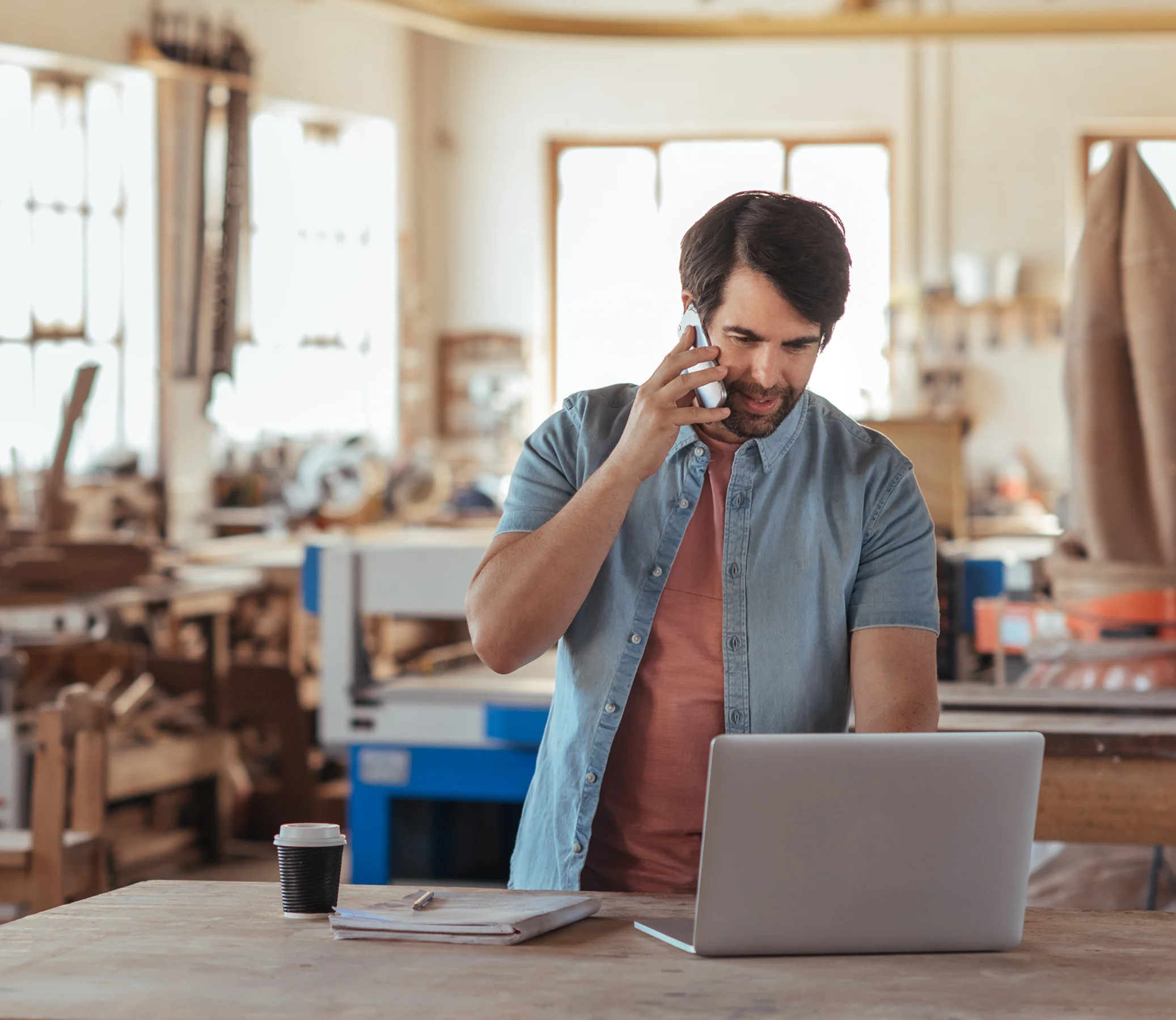 A man on the phone using laptop
