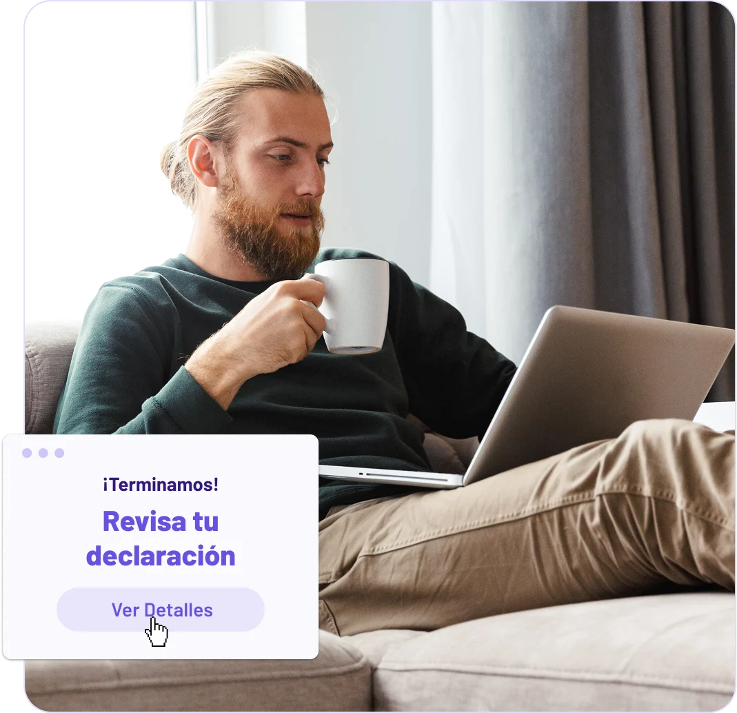 man drinking coffee and working on a laptop