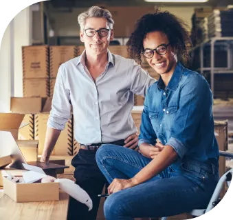 Trusted filing with guaranteed accuracy image two men smiling in warehouse