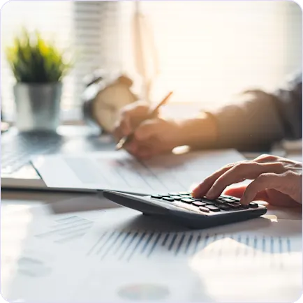 filer working on calculator and writing notes