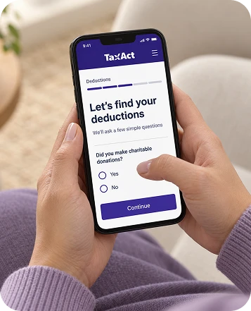 Close-up of a person wearing a lavender sweater and using the TaxAct mobile app to answer a question about charitable donations.