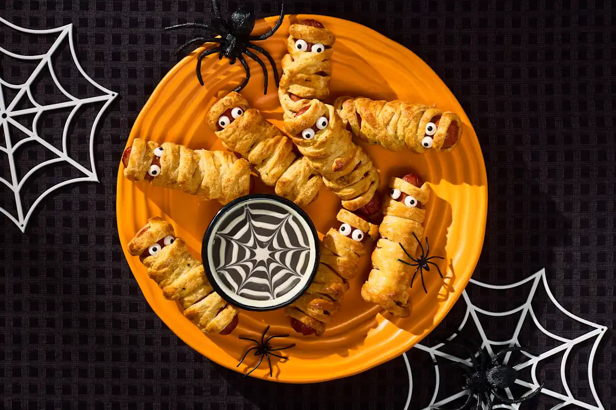 Halloween mummy ranch hot dogs with spooky ranch dip and spiderweb design