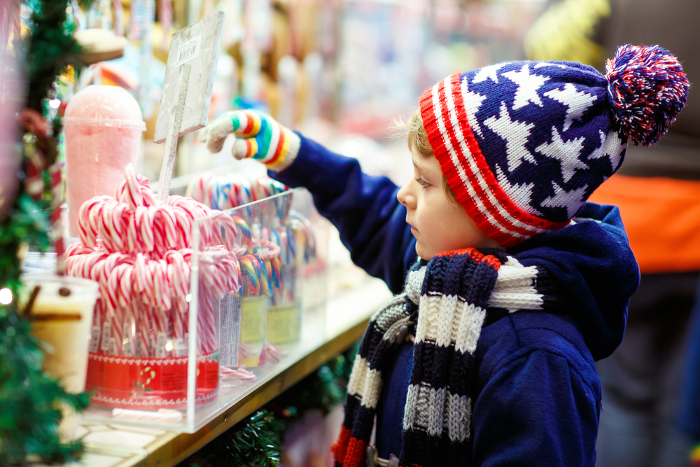 Kid-in-a-Candy-Store-Picking-Out-Candy-Canes-for-Xmas 715234096