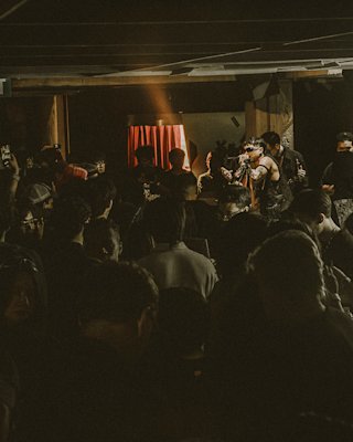 A band is playing in a crowded venue