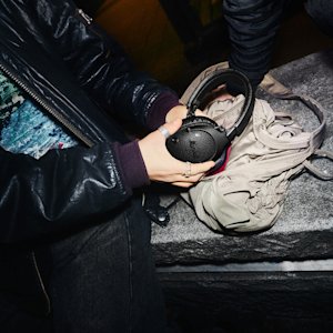 A person holding Monitor III A.N.C. Pitch Black