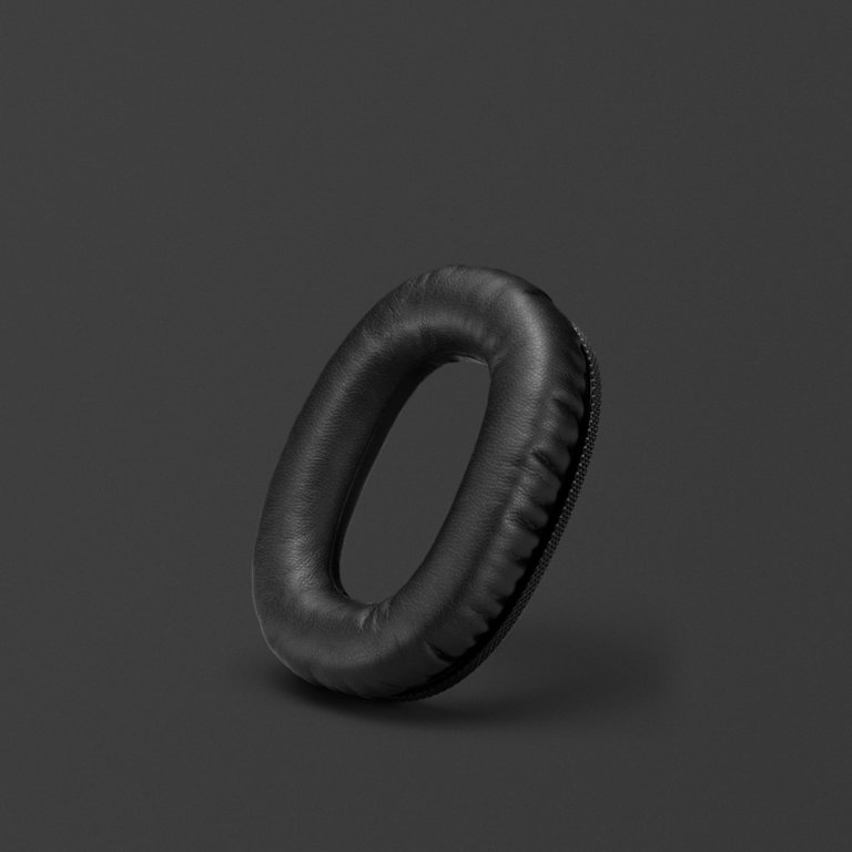 A MONITOR II A.N.C. black ear cushion on a grey background.