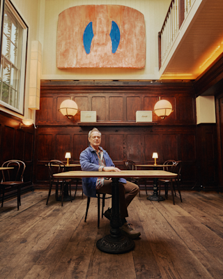 Frank Falcinelli sat at a table of his restaurant.