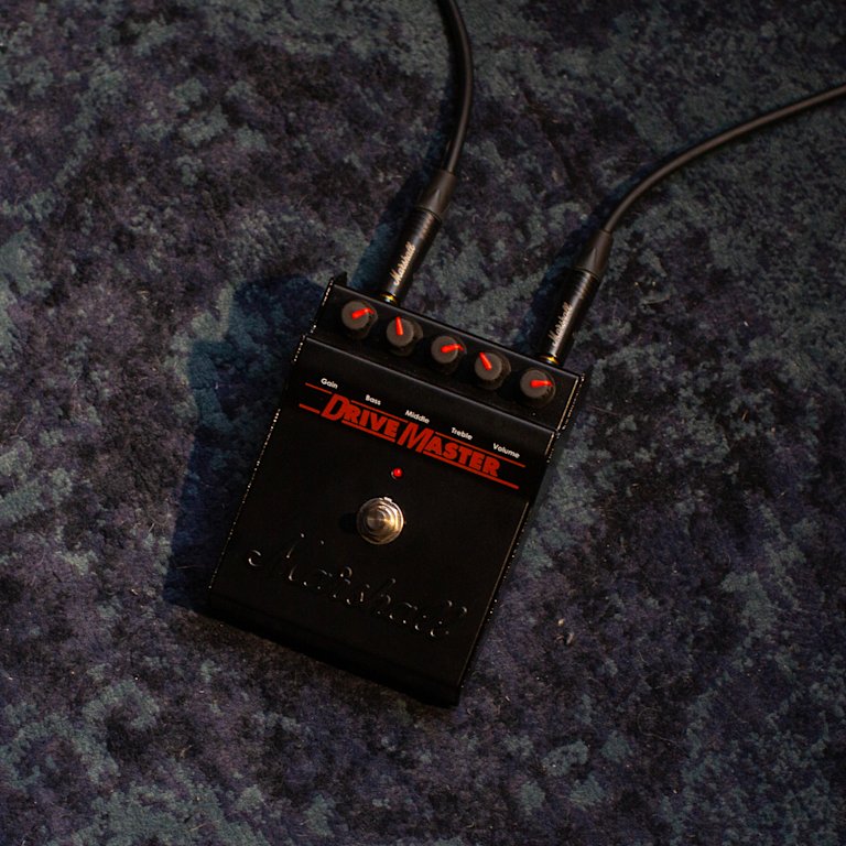 drivemaster pedal with red text on grey carpet