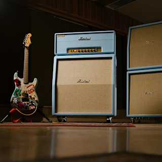 Billie Joe Armstrong's electric guitar stands next to a Marshall 1959BJA amplifier stack.