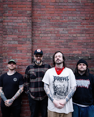 The Cancer Bats together in front of a brick wall