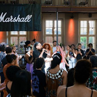 A person is singing around a happy crowd