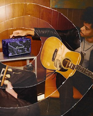 A musician listening to music in the Acton III Marshall x Hendrix 60th Anniversary Edition