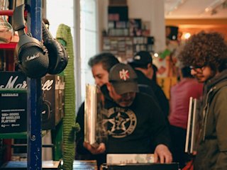 People browsing vinyls in-store, Marshall headphones in focus