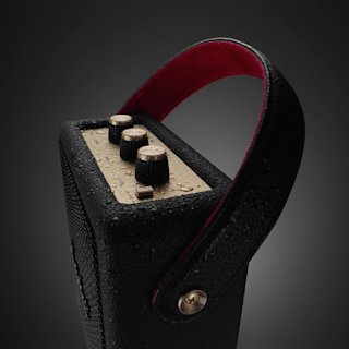 Close-up of a Stockwell III Black and Brass, featuring three control knobs and a black handle lined with red on the inside.