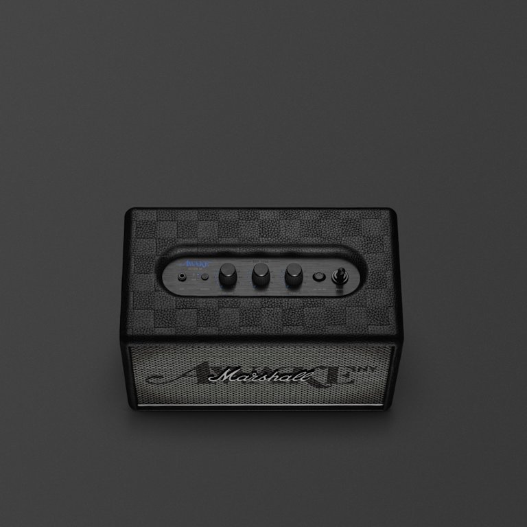 The Acton III Awake NY Edition bluetooth home speaker with three control knobs on top and the iconic "Marshall" logo on its front grille, set elegantly against a dark background.