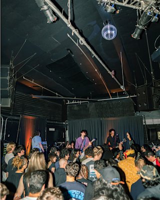 People enjoying live music inside a small venue