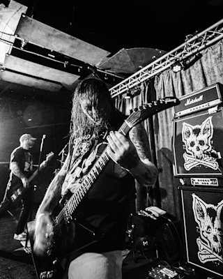 A person is playing an electric guitar on stage