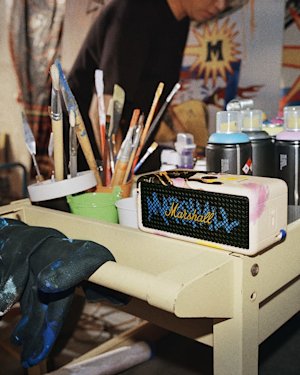 A paint-splattered cart with brushes, paint bottles, and Emberton III Lunar New Year Edition 2026.