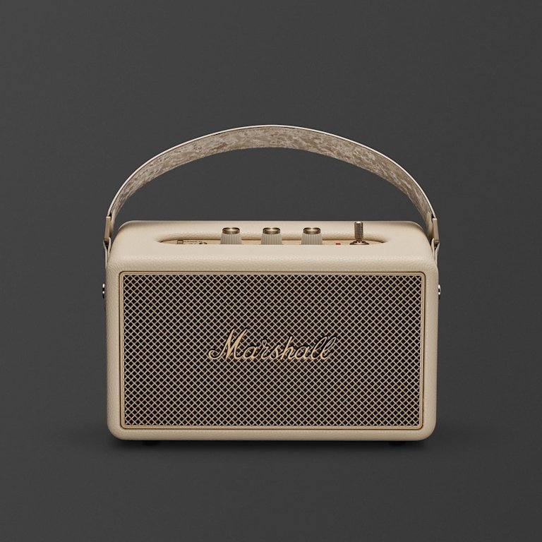 Marshall Kilburn III Cream portable Bluetooth speaker, featuring a mesh front, gold logo, top control knobs, and a handy carrying handle.