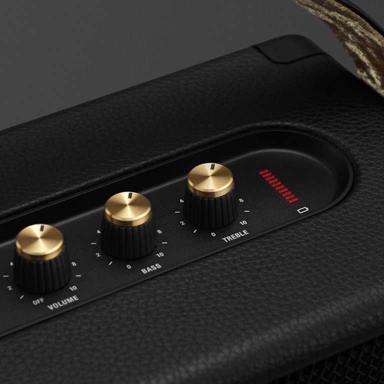A close up of a Marshall KILBURN II BLACK AND BRASS speaker with gold knobs.