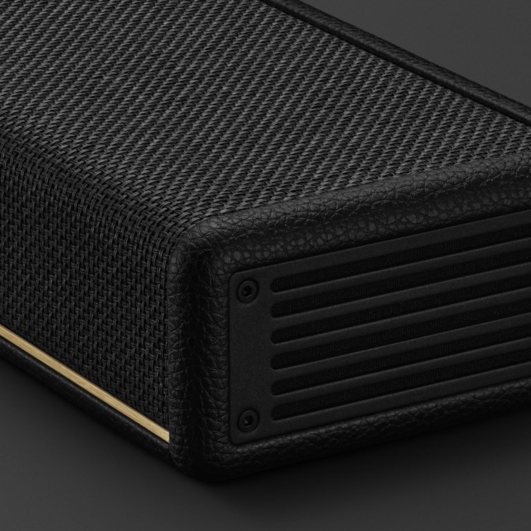 A close-up of the corner of the Marshall Heston 120 with a textured finish, perforated panel, and gold accent stripe.