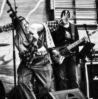 A person singing with a band in the background