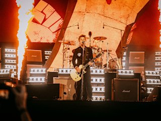 Bille Joe Armstrong performing in an orange stage