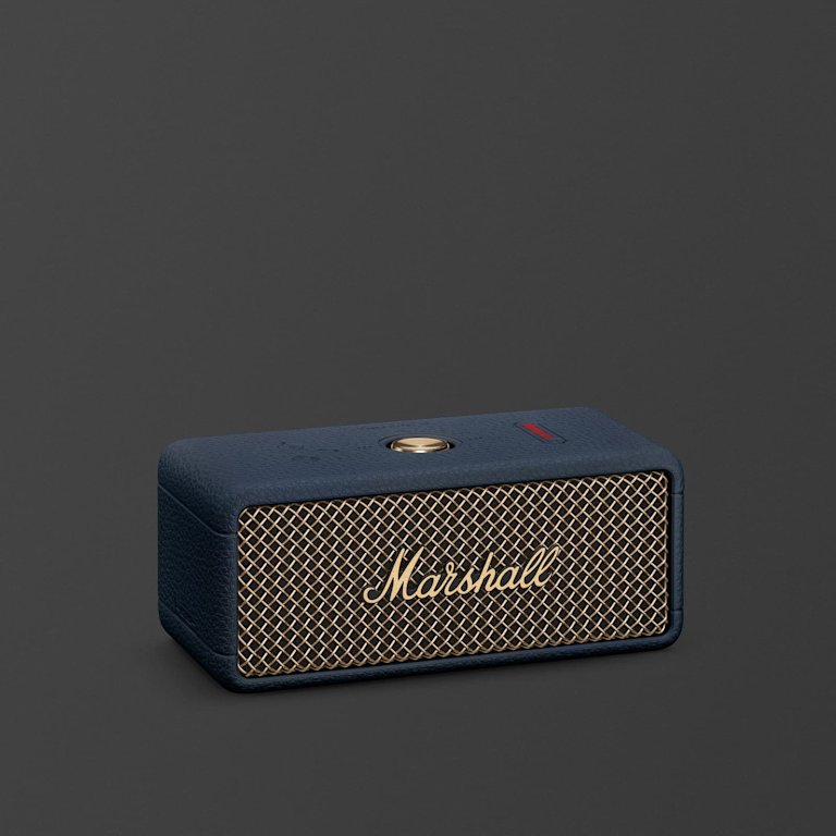 Marshall Emberton III Midnight Blue portable Bluetooth speaker featuring striking gold accents is displayed against a plain dark background.