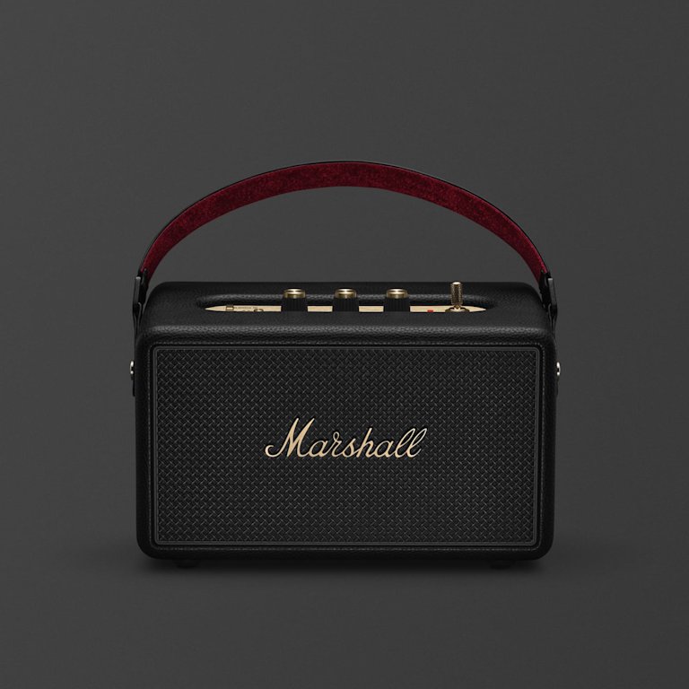 Marshall Kilburn III Black and Brass portable Bluetooth speaker, featuring a gold logo and brown carrying handle, is shown from the front against a plain background.