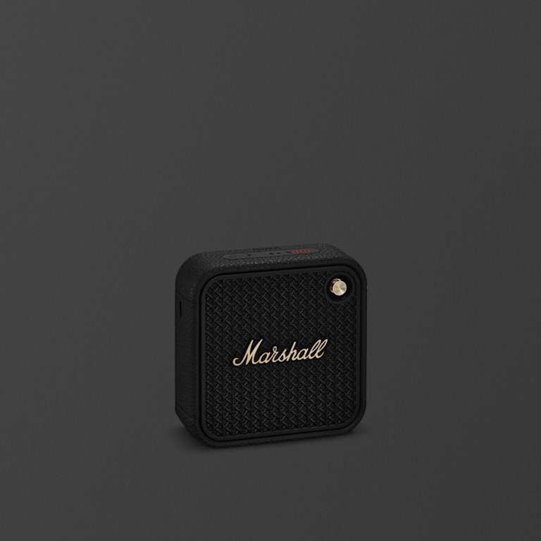 Marshall Willen II Black and Brass portable bluetooth speaker against a dark backround.
