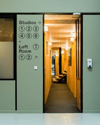 A door with arrows pointing toward the studios and loft rooms