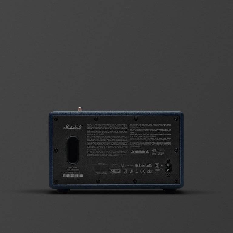 Rear view of the Marshall Acton III Midnight Blue Bluetooth speaker displays its branding, ports, and connection labels against a dark background.