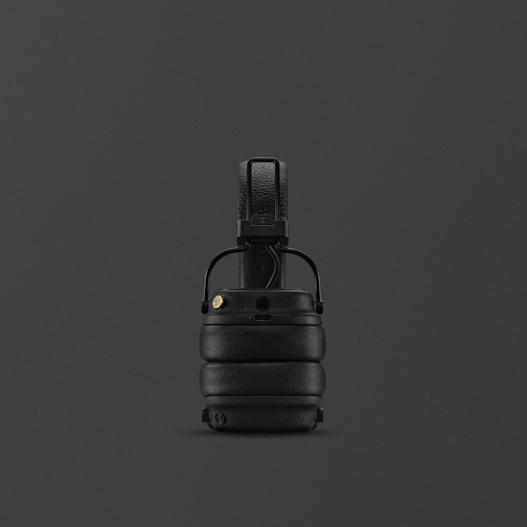 Folded Marshall Major V Black on-ear wireless headphones against a dark background.