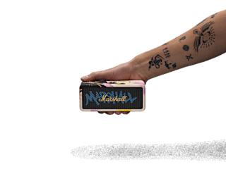 A tattooed arm holds Emberton III Lunar New Year Edition 2026 portable speaker against a black background.