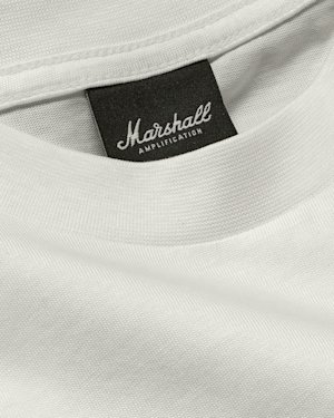Close-up of a white cotton t-shirt, showing stitching detail along the hem.