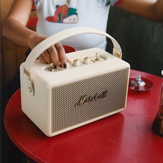 A beige Kilburn being adjusted by a person