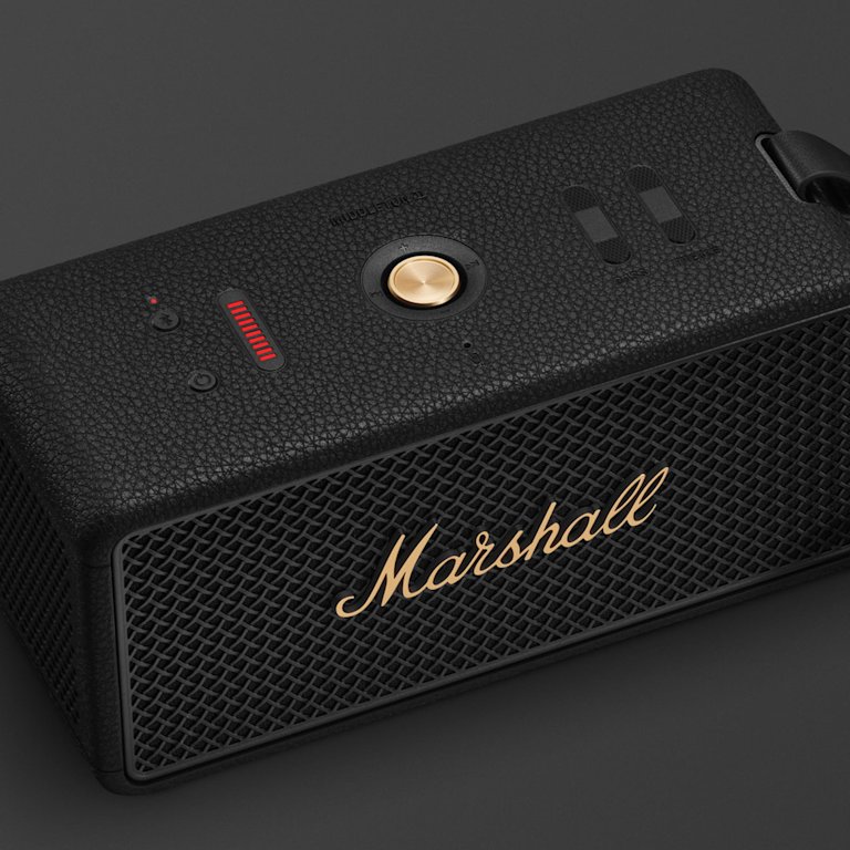 Marshall Middleton II Black and Brass portable Bluetooth speaker with a textured surface, gold control button, and front logo sits on a dark background.