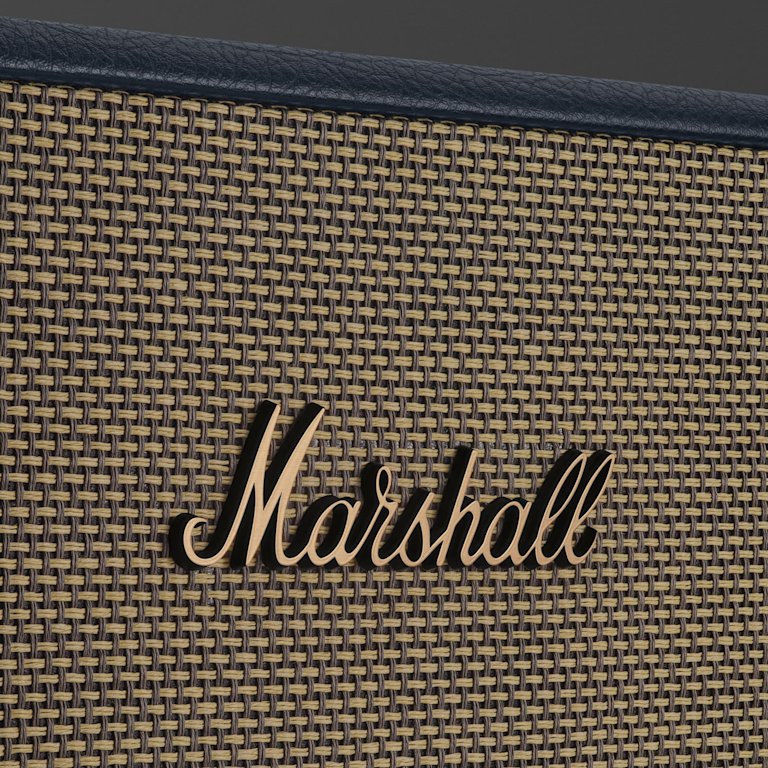 Close-up of the Marshall logo on the woven grille of the Acton III Midnight Blue Bluetooth speaker.