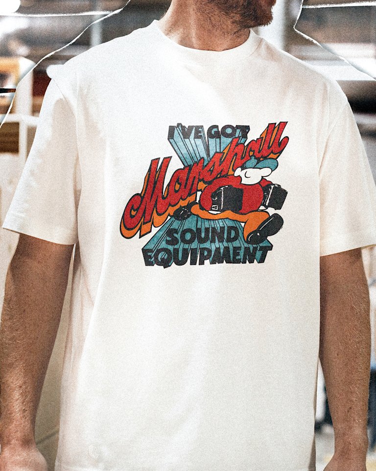 A person wearing a white Marshall t-shirt