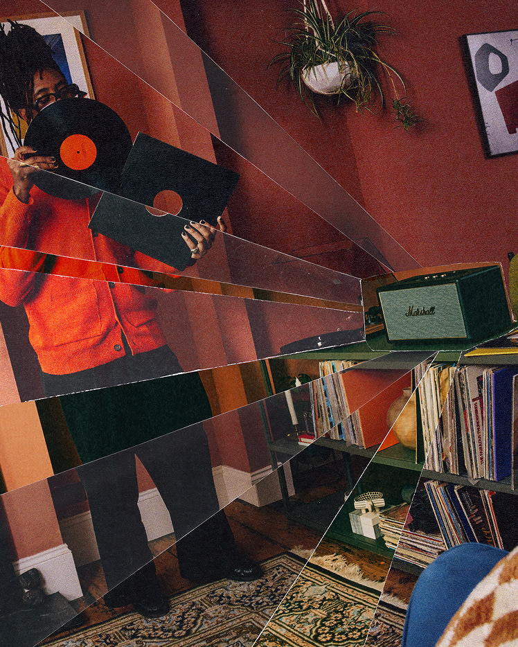 A person holding a vinyl record stands near a shelf with records, Marshall Stanmore IV Black speaker, and plants in a warmly lit, retro-styled room.