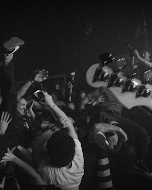 The crowd of a gig in a black and white image