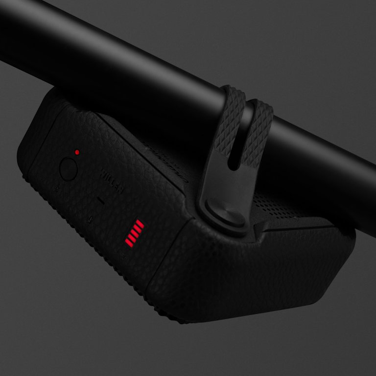 A Marshall Willen Black and Brass portable speaker with a black device and a red light attached to it.