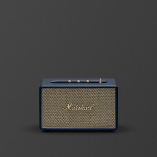 Marshall Acton III Midnight Blue Bluetooth speaker with gold knobs and a gold mesh front sits on a plain dark background.